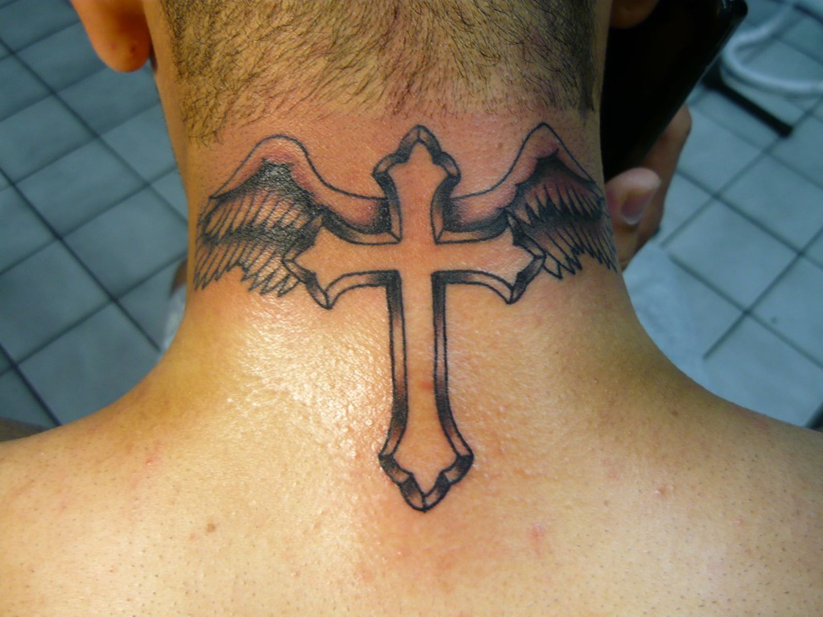 The Fascinating History And Surprising Reasons Behind Neck Cross Tattoos
