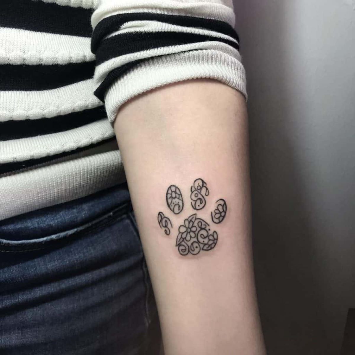 The Surprising Meaning Behind Women's Dog Paw Tattoos
